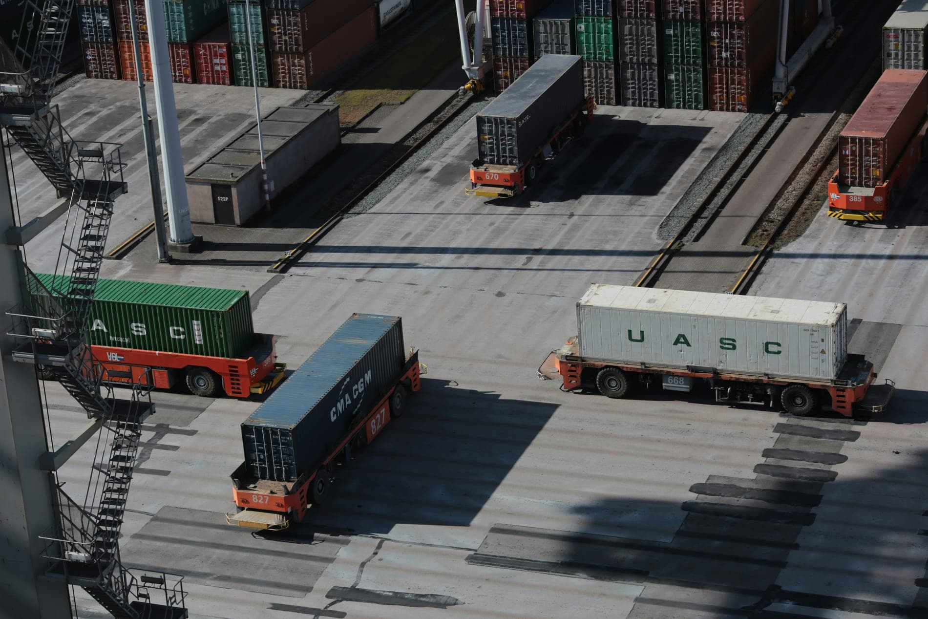 Carriers and stacked containers at a port seen from above
