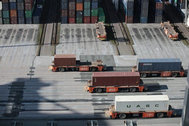 Container carriers lined up on tracks in a port yard