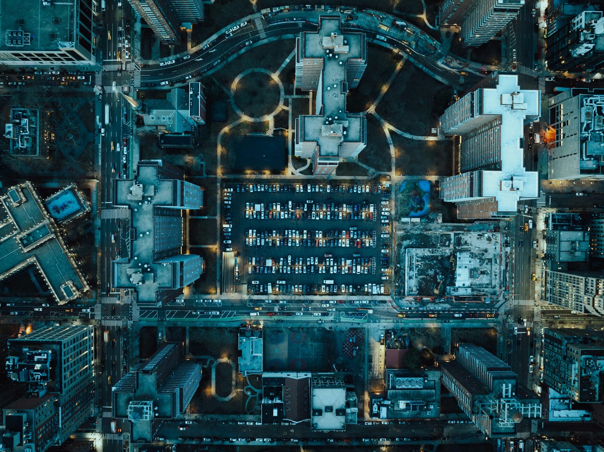 Aerial night view of a city block with lit streets