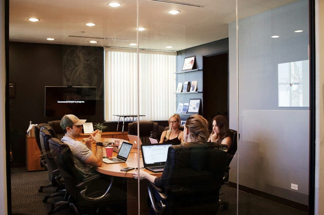 Colleagues around a conference table in a meeting room